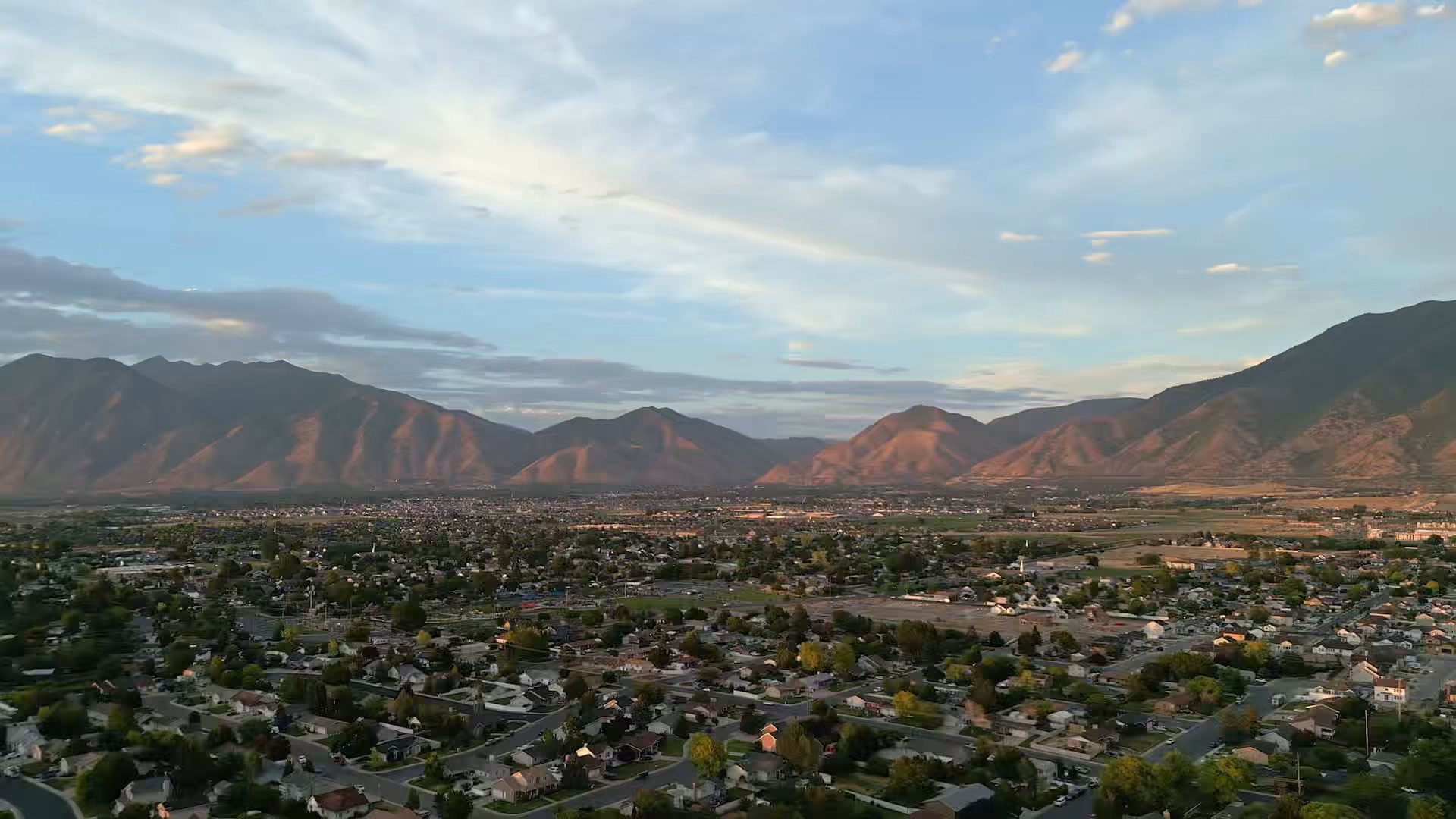 Aerial view of Utah County neighborhoods below the Wasatch Mountains