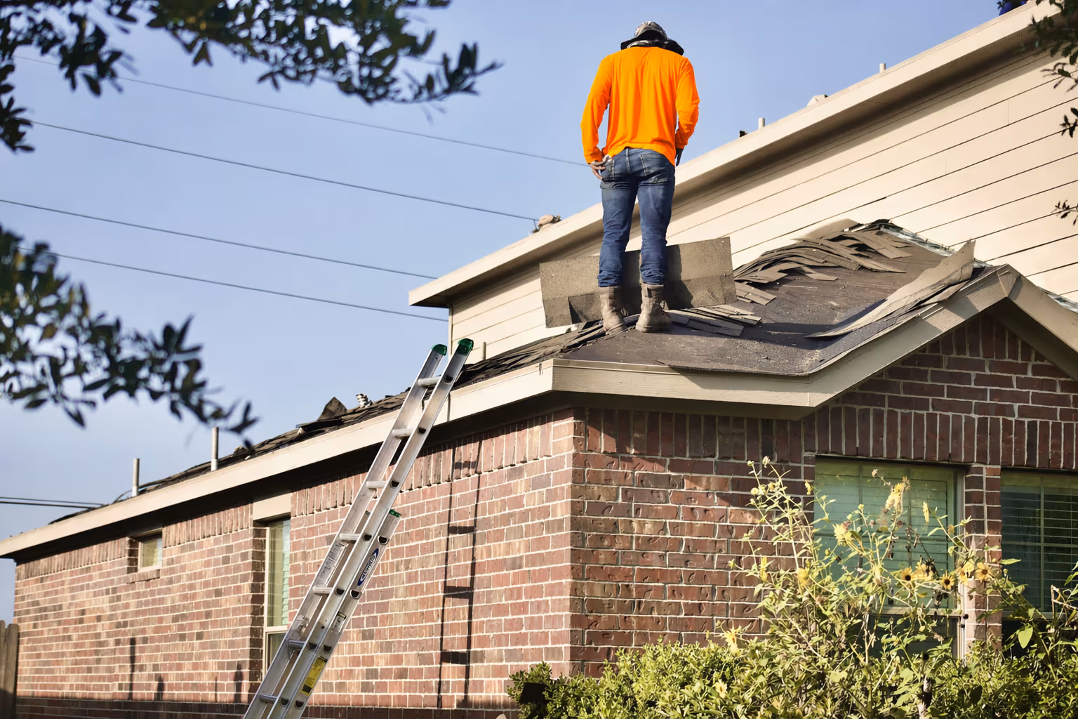 Phoenix Exteriors crew performing a full tear-off during a residential roof replacement in Utah County